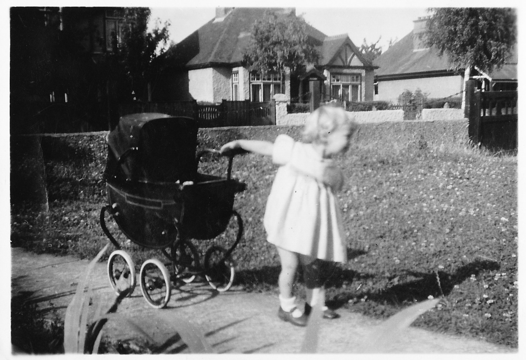 photo of child with old style pram was taken in the garden on 28 Woodside Wigmore Kent in the summer of 1946